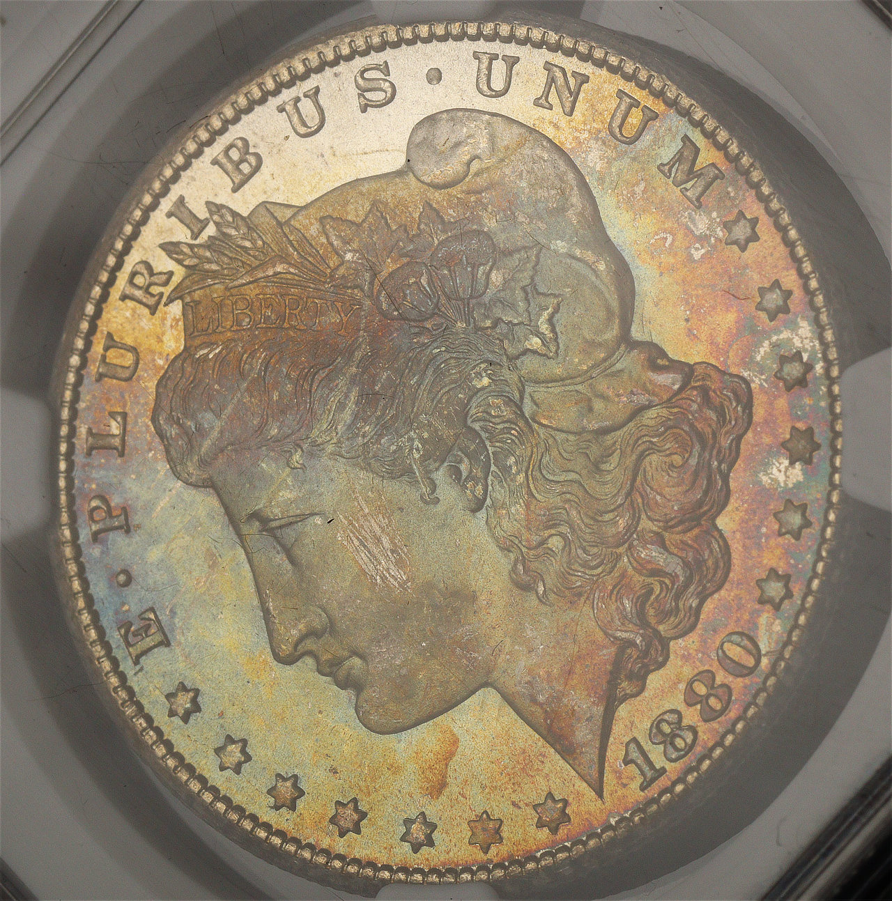 Gallery image of this 1880-CC Morgan Dollar NGC MS-67 Rainbow Obverse Crescent Toning